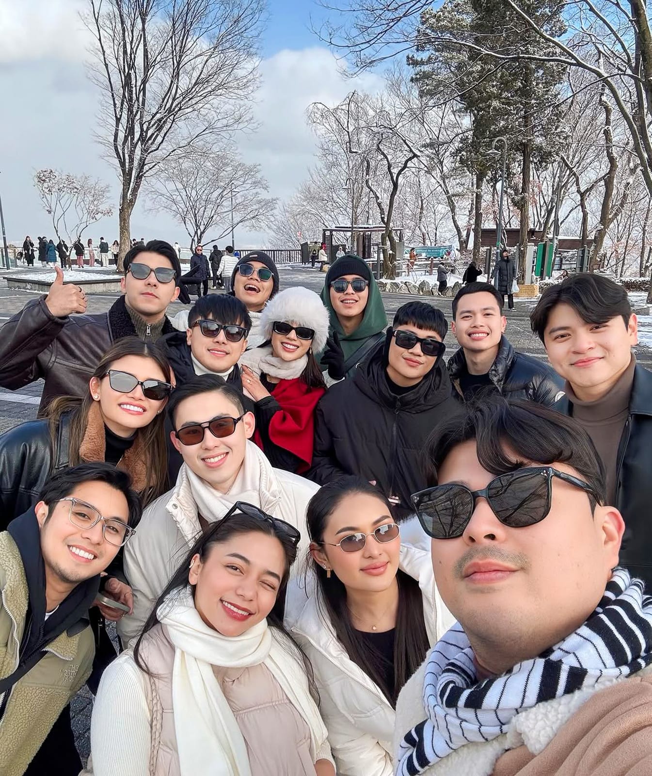 A celebrity group selfie on a snowy day in South Korea with Avian Summit Travel