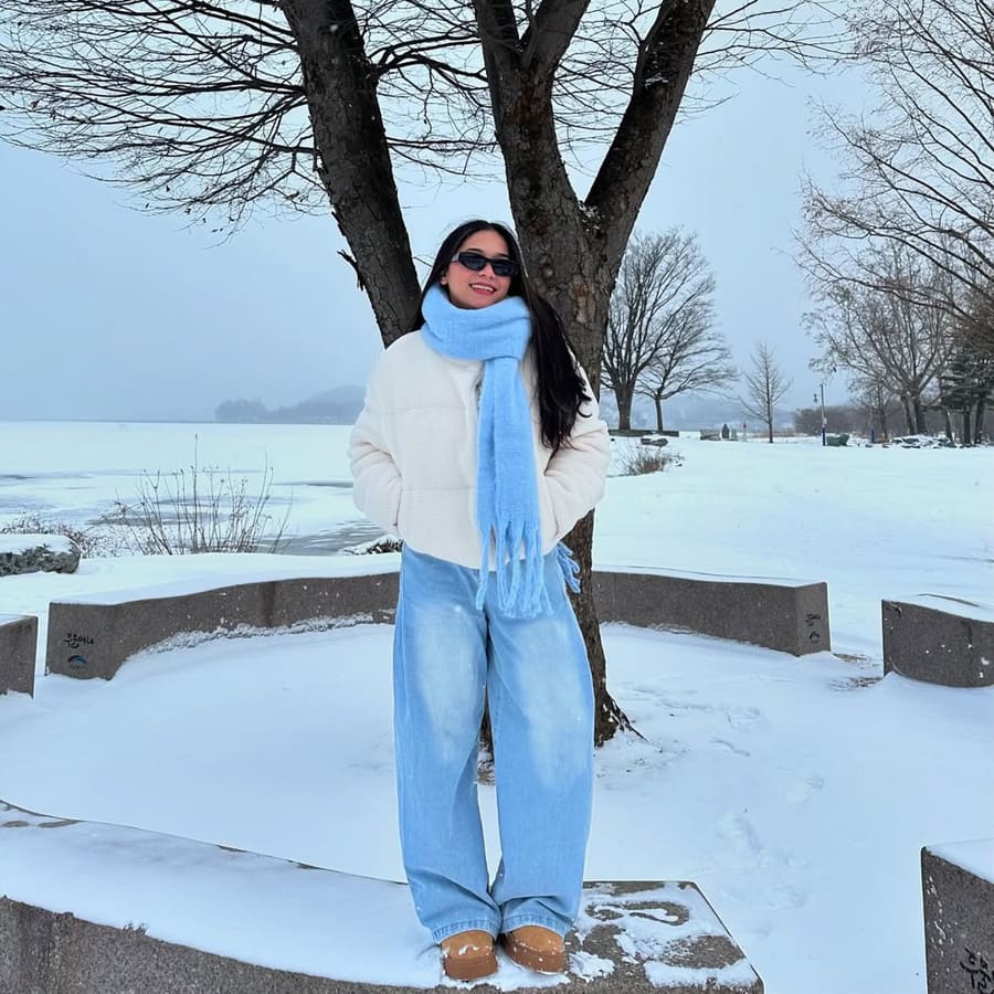 Forda Ferson by the frozen river at Dumulmeori, South Korea, travelling with Avian Summit Travel